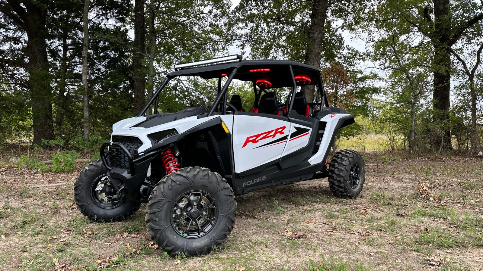 White 2024 Polaris RZR XP 4 with the AudioFormz stereo top, light bar and red LED speakers